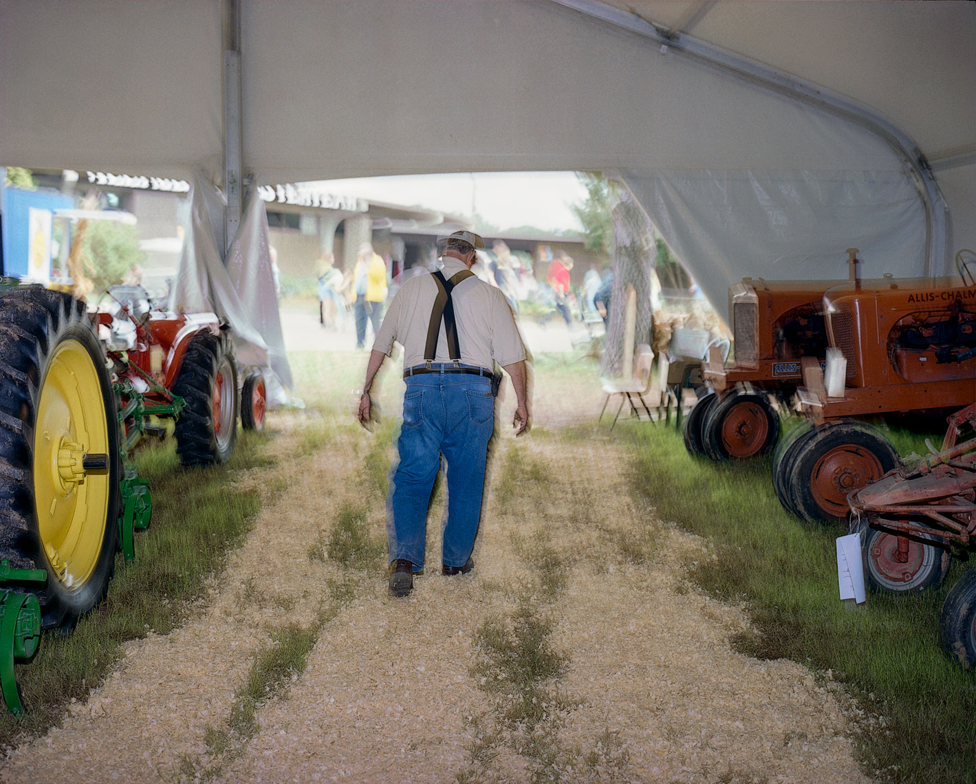 Farmer under a tractor tent, North carolina State Fair
